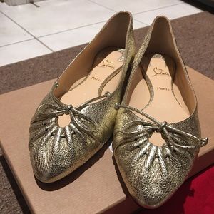 Christian Louboutin flats in gold (worn once)